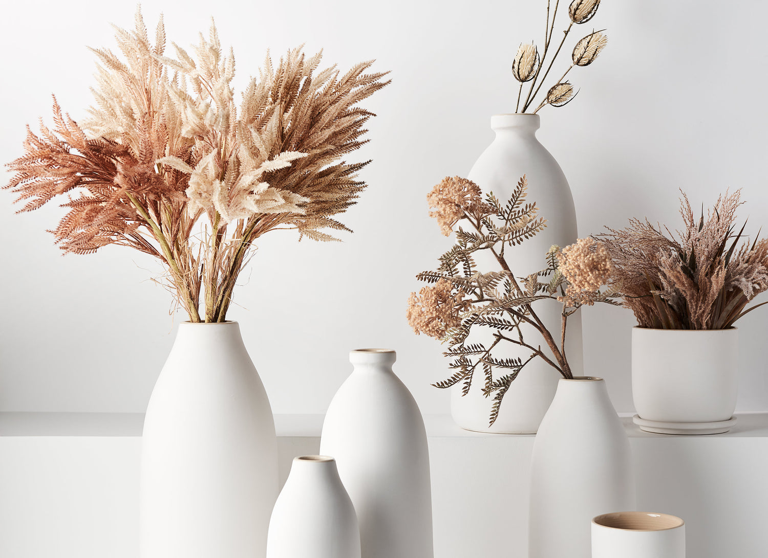 Home decor of Scandinavian style white Cavo Vase in varies design with dry flowers.